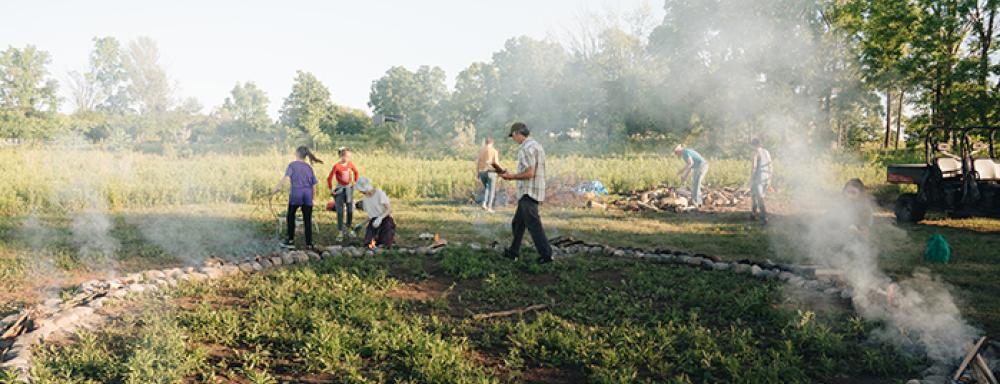 A circle made of stone clay with stick burning within the border. 