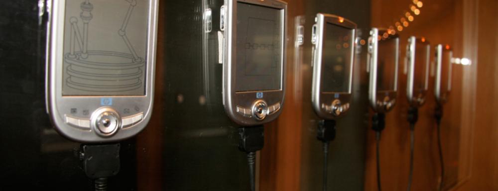 a line of mounted "pocket PC" with different illustrative imagery on the screens.