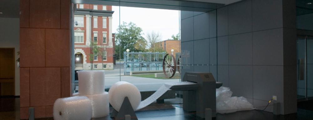 A machine that take big rolls of bubble wrap, on the left,  and pops it. 