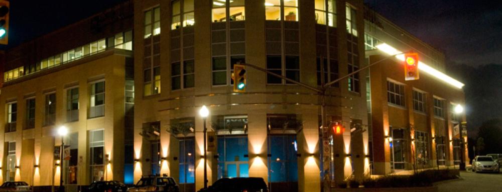 Building with blue light emitting from within.