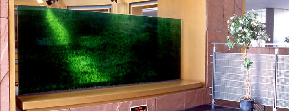 A rectangle of turf vertically displayed with keep off grass sign