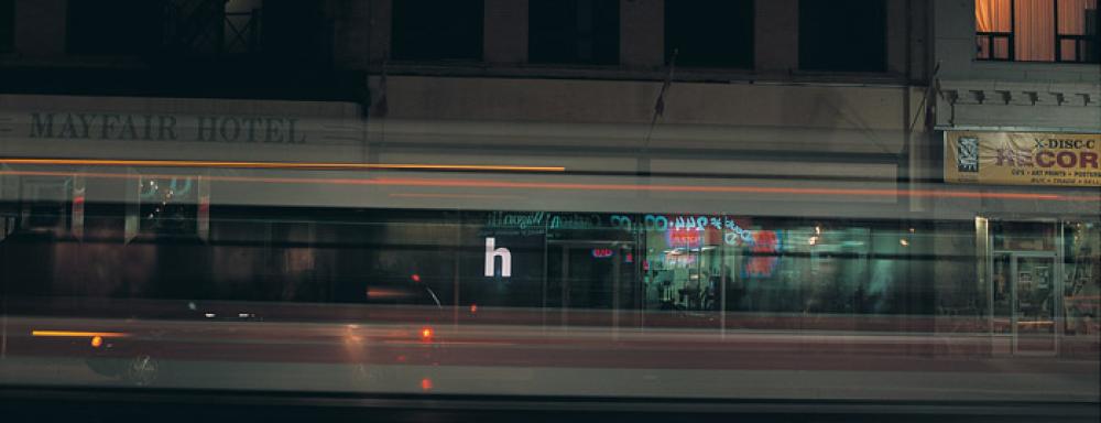Motion blurred image of cars with small letter h on in center