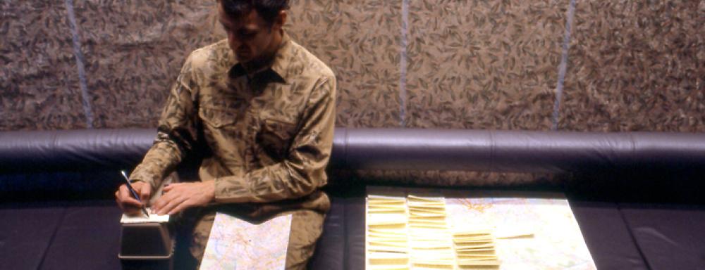 Person sitting with map in lap writing notes