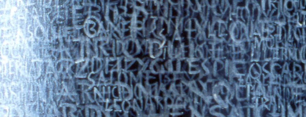 Layered handwritten language, symbols, and marks are a central motifs for this work which transforms a column into a work of art.