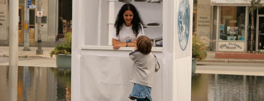Woman in booth talking to child