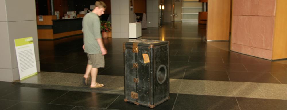 Man looking at black chest suit case