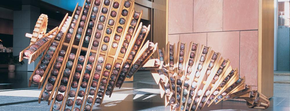 Large sculpture with vertical strips that hold large balls