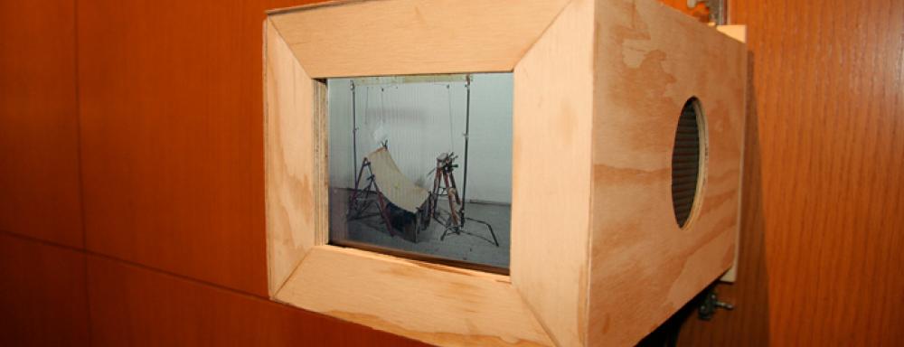 a wooden box with video of chair like structure 
