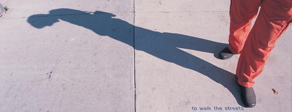 legs with shadow of human and small text that says "to walk the street"