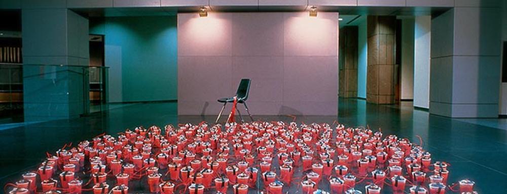 Red solo cups connected by electrical wires to a chair