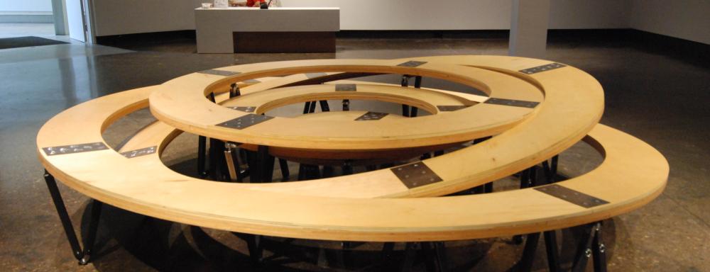 Multiple wooden circles inserted inside each other some of tilter 
