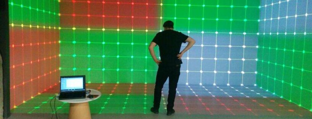 Jesse standing in the hive whit is a room with coloured lit up walls