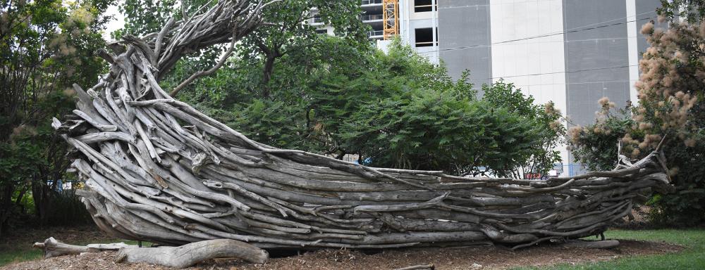 A viking ship made of driftwood among green trees
