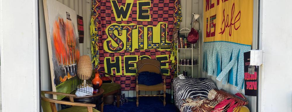 A sea can decorated to look like an bunker lived in by black people