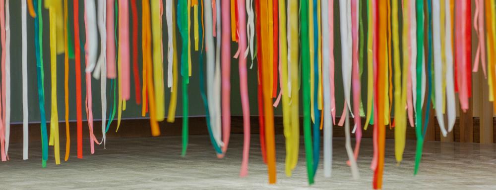 Close up of colourful ribbons hanging together.