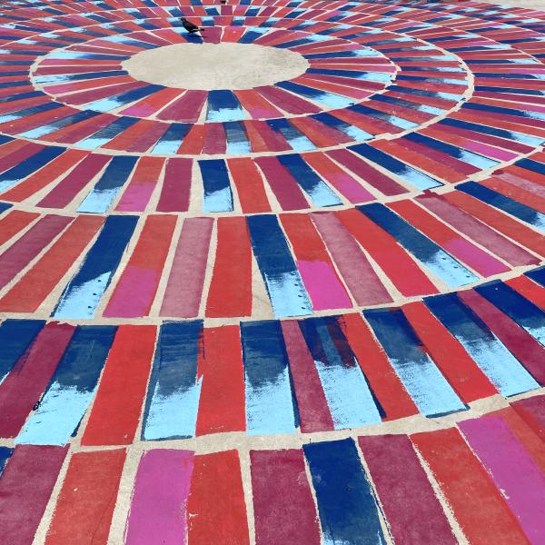 Colourful image of red and blue paint on a concrete surface. 