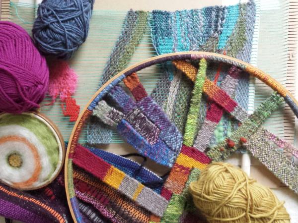 Image of coloured yarn on a circular cardboard loom.