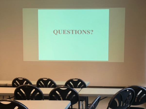 Projected image that says "QUESTIONS?"