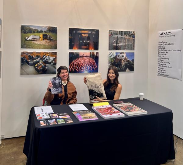 CAFKA staff at a booth at Art Toronto holding up merch