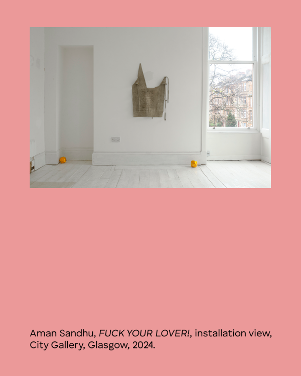 Exhibition view of Aman Sandhu's artwork "Fuck Your Lover" at City Gallery, a gallery that resembles a domestic space with all surfaces painted white, with natural lighting. Sandhu's artwork is a hanging textile featuring written text, with two vibrant orange waste-paper balls on the floor. 